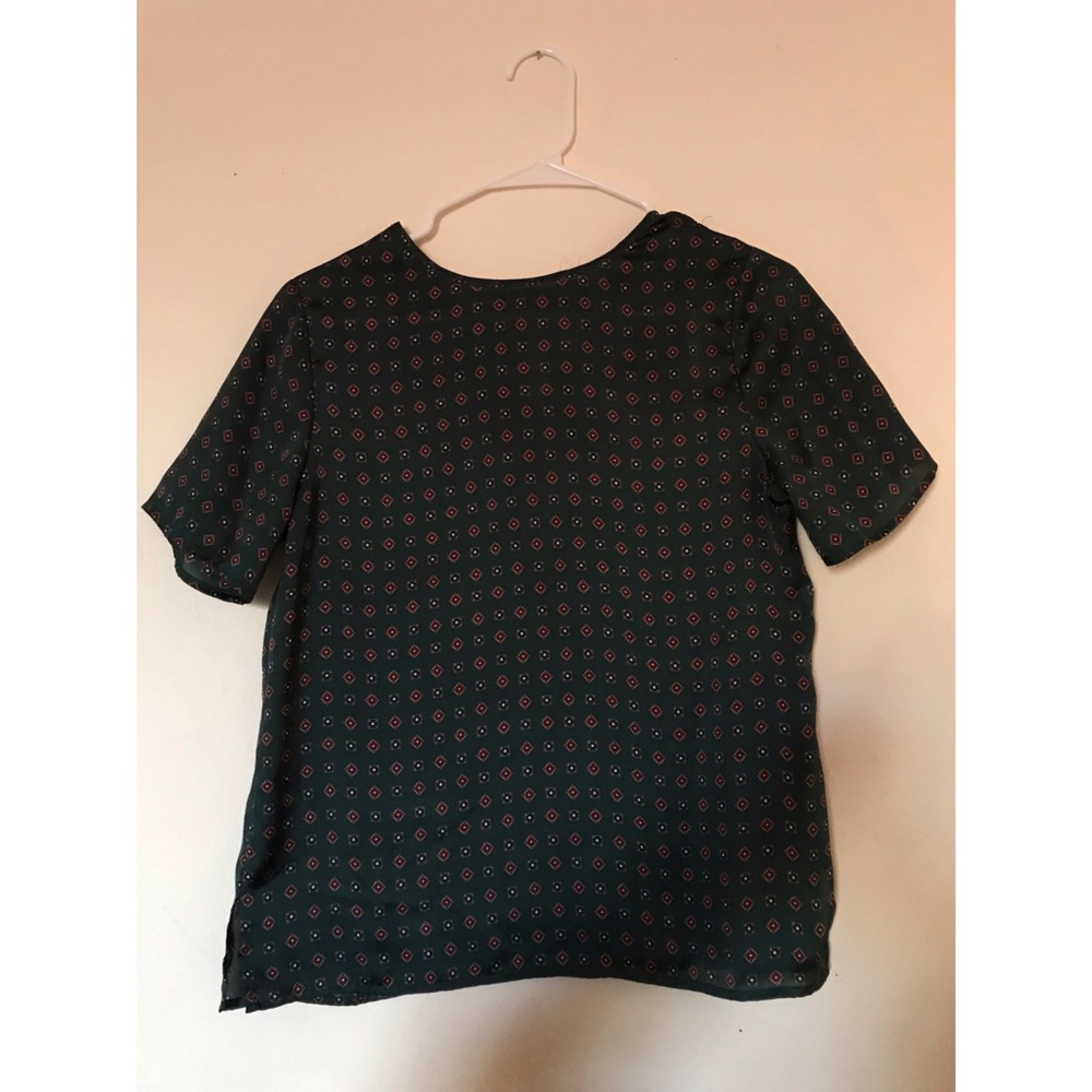 Green patterned blouse.